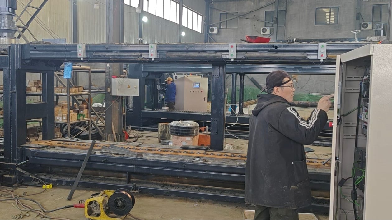 Technician wiring an electrical control cabinet during machine commissioning