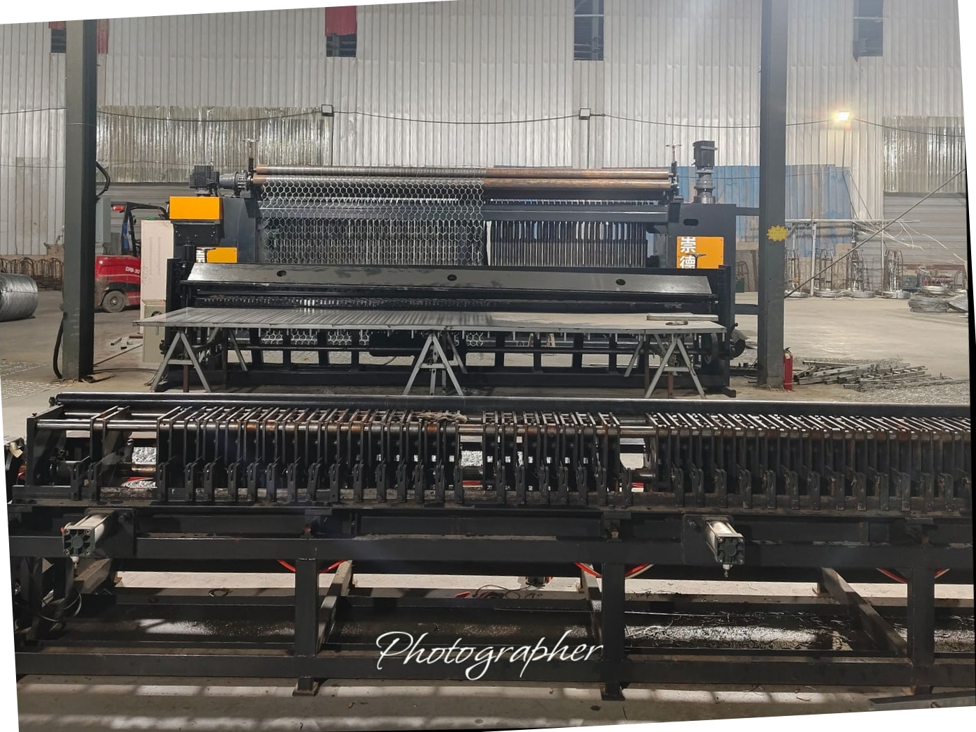 CNC gabion mesh weaving machine in the workshop with hexagonal mesh on the loom